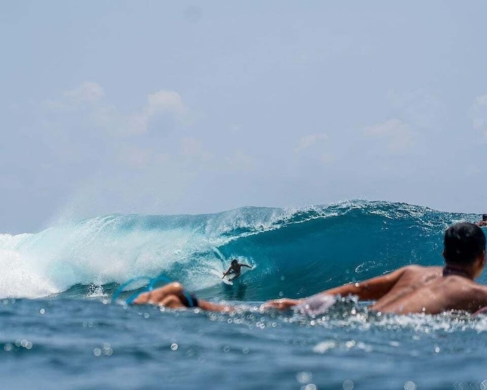 A surfer riding a large wave in the ocean. 1