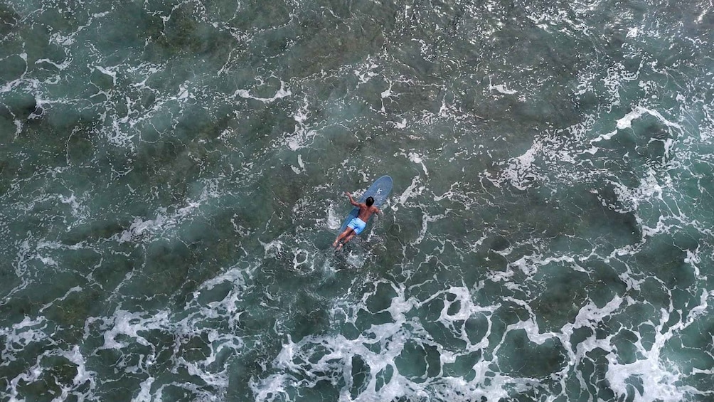 A person surfing on a wave in the ocean. 3