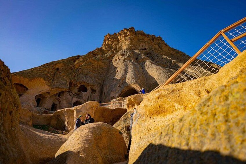 A cave with large rock formations and a wooden structure. 3