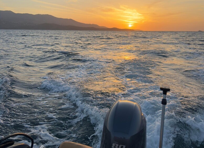 A boat's wake in the ocean with a sunset in the background. 4