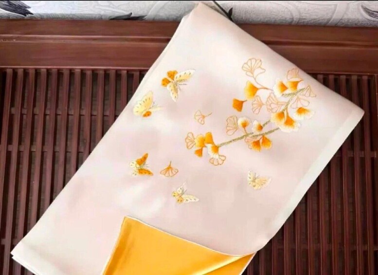 A folded fabric with a floral pattern and a yellow corner. 2