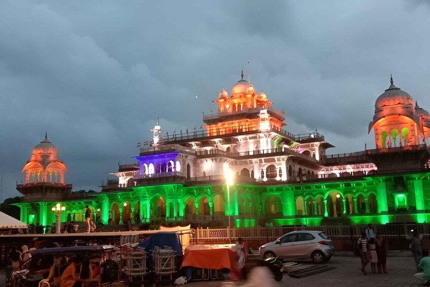 A historic building with multiple domes, illuminated by colorful lights. 4