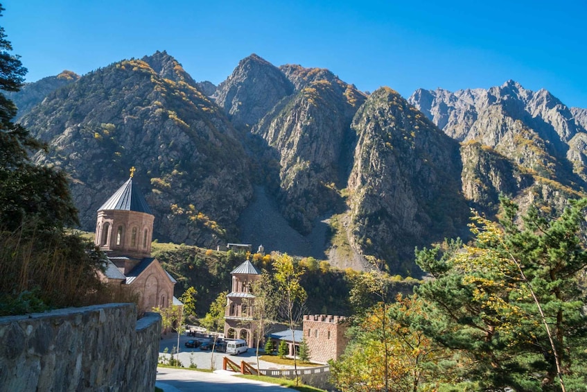 A mountainous landscape with a church, a tower, and a castle-like structure. 5