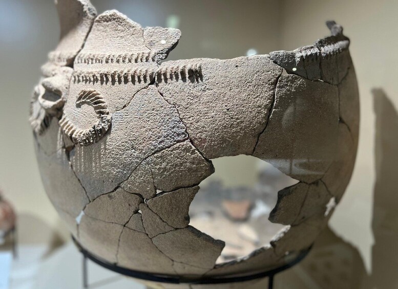 A cracked ceramic globe with a detailed depiction of a horse. 5