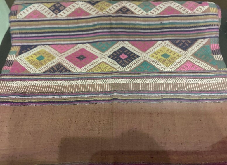 A patterned fabric with geometric designs and stripes. 3