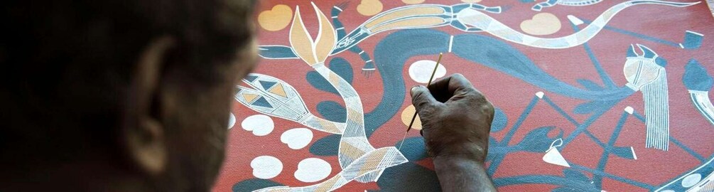 A person painting a mural with abstract designs. 4