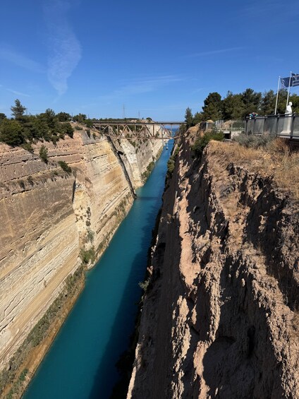 A river canyon with a bridge and a statue. 5