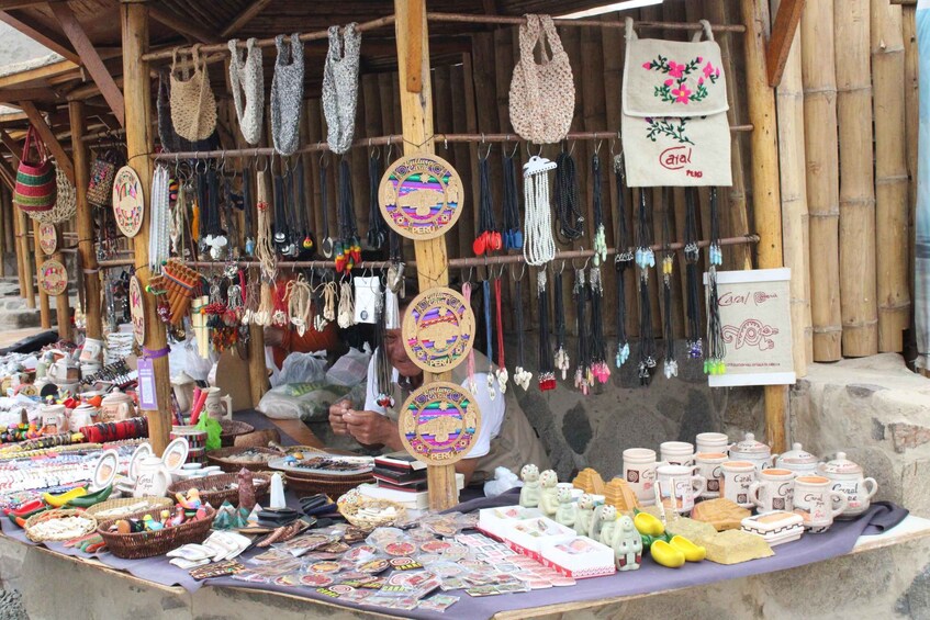 A market stall with various handicrafts, including woven bags, jewelry, and ceramic items. 4