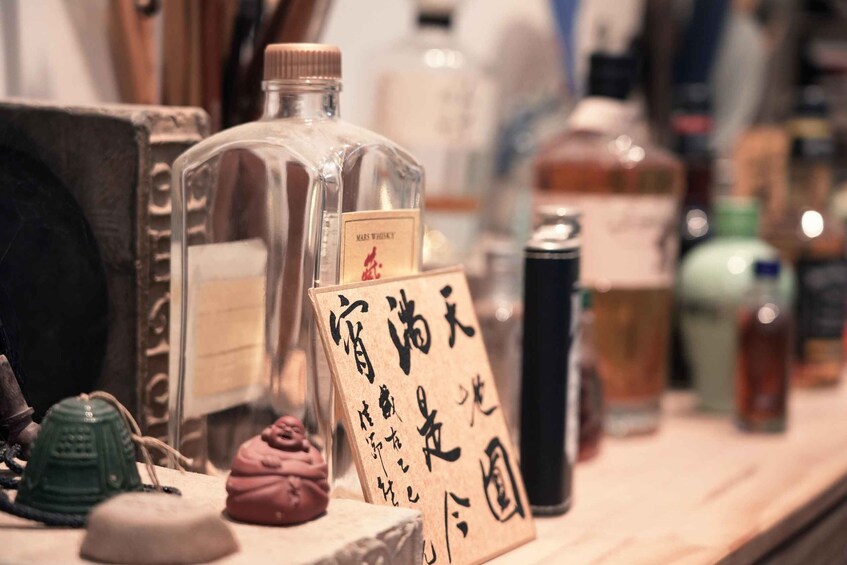 A bottle of Mars whiskey and a sign with Japanese characters. 3