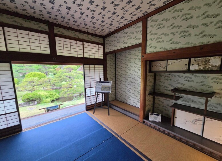 A traditional Japanese room with tatami flooring, shoji screens, and a view of a garden. 5