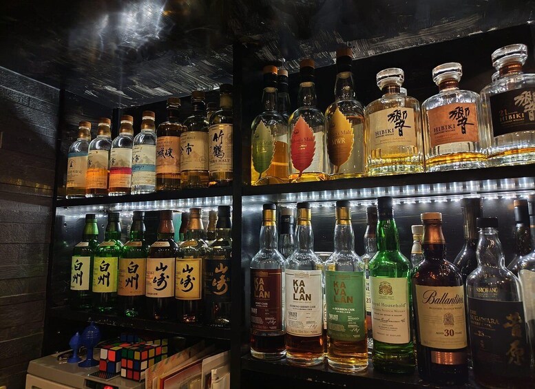 A bar with shelves of liquor bottles, including Hibiki and Ballantine's. 2