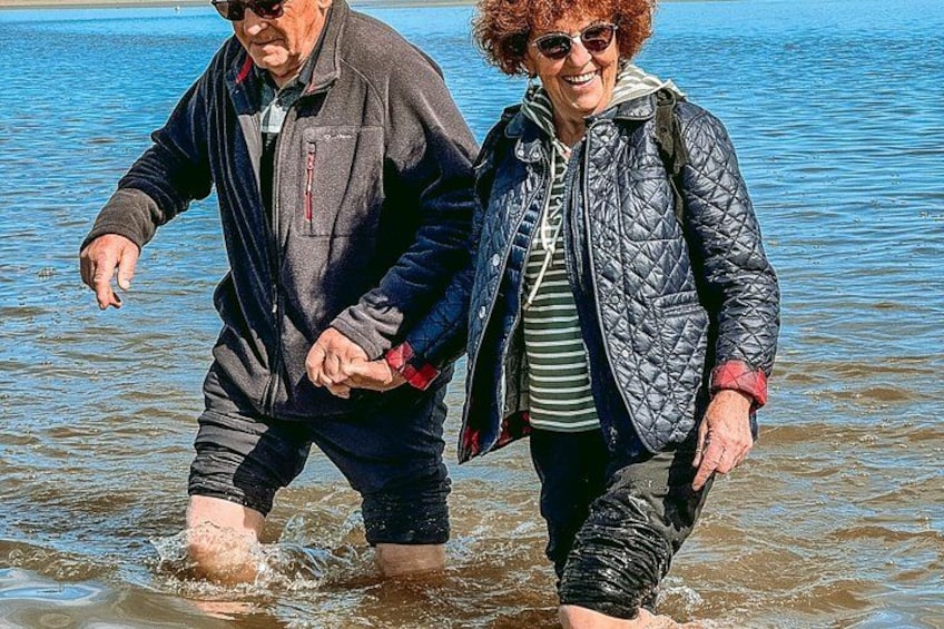 Two people wading through shallow water. 5