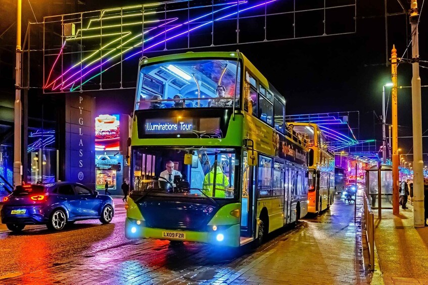 A double-decker bus on a wet street at night with colorful neon lights above. 1