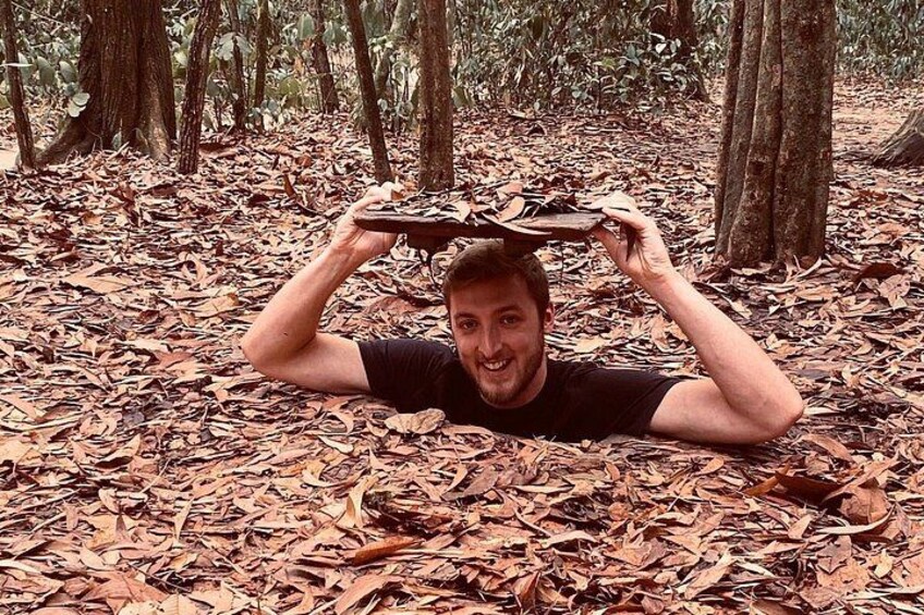 A person lying on the forest floor surrounded by dry leaves. 1