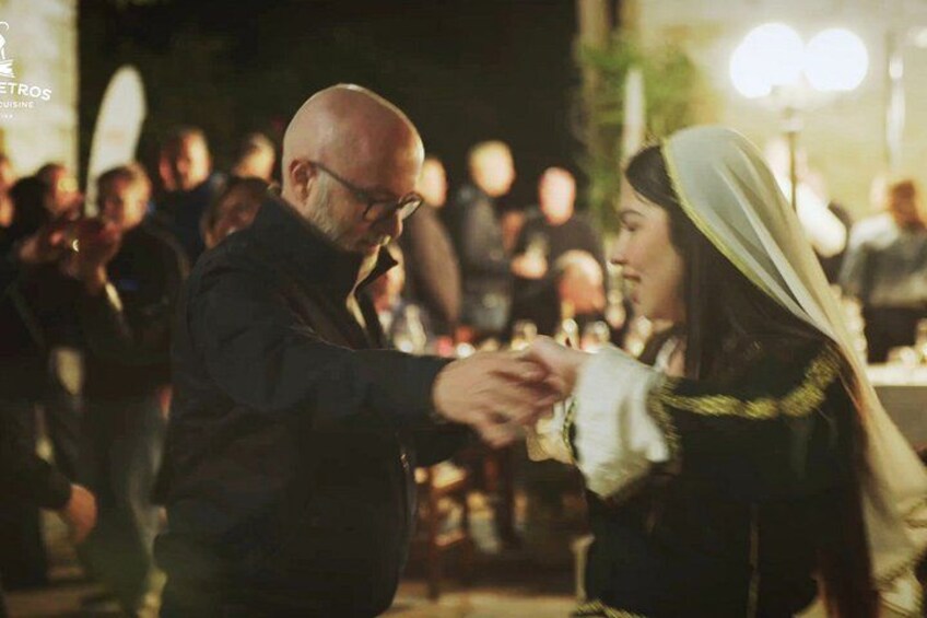 A person holding hands with another person at a social event. 2
