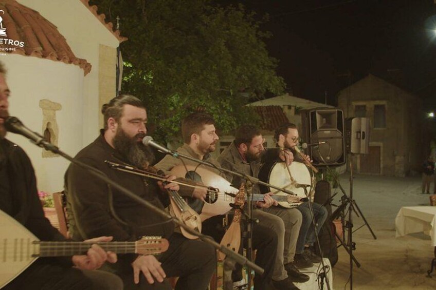 A group of musicians performing outdoors at night. 3