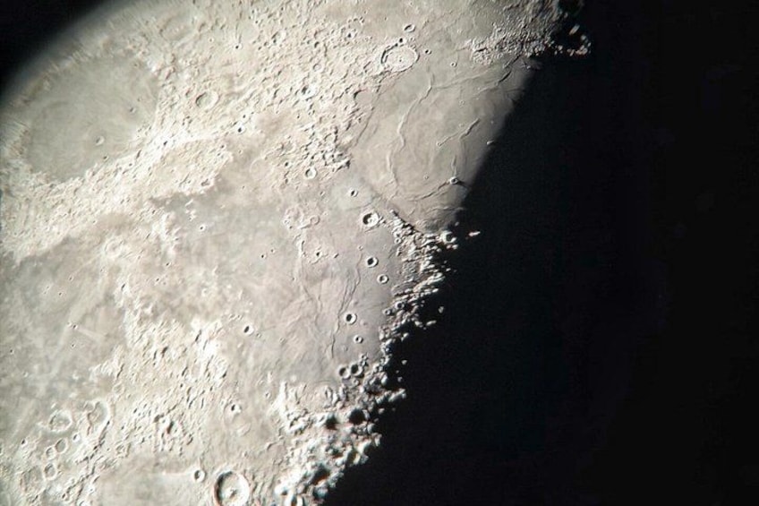 A lunar surface with craters and shadows. 2