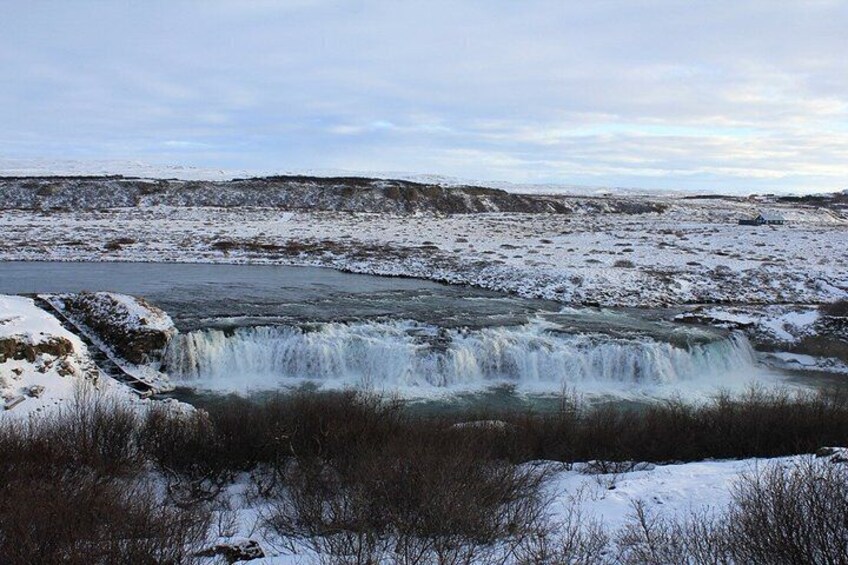 A snowy landscape with a waterfall. 2