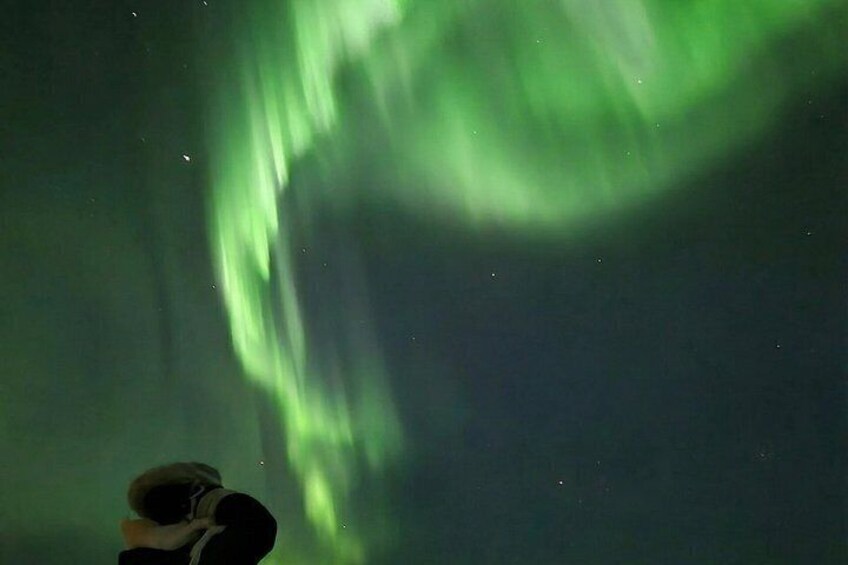 A person taking a photo of the Northern Lights. 2