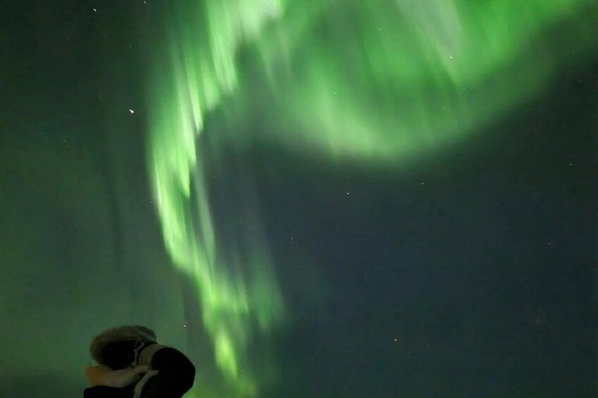 A person taking a photo of the Northern Lights. 3