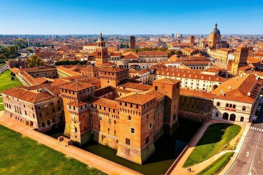 A historic fortress with red-tiled roofs, a central courtyard, and a river. 1