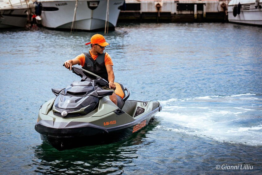 A person riding a jet ski on calm water with boats in the background. 2