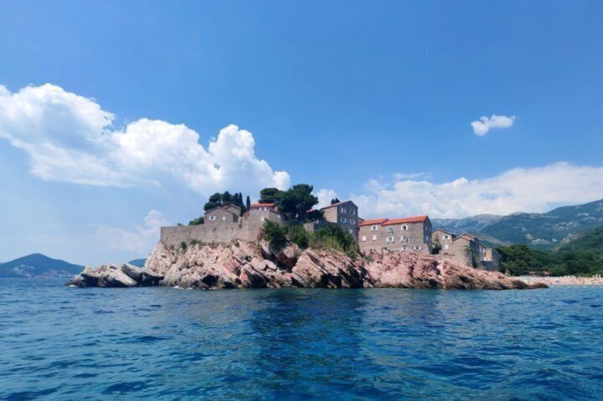 A coastal fortress with a red-roofed building on a rocky outcrop. 3