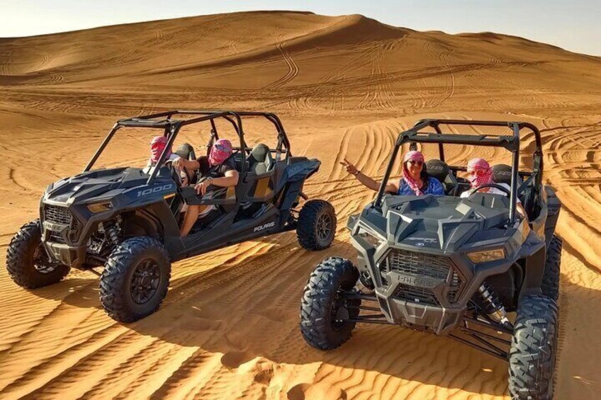 Two Polaris 1000 off-road vehicles on a desert sand dune. 4