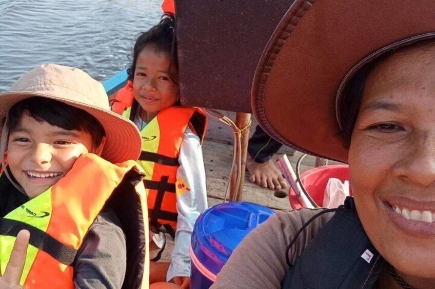 People wearing life jackets and a hat, near a body of water. 4