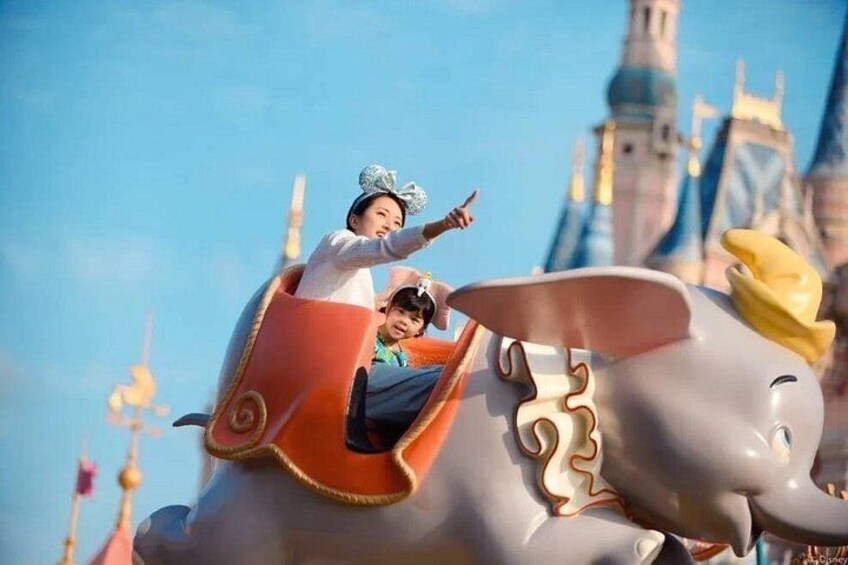 A ride on a themed vehicle with a character, a child, and an adult. 3