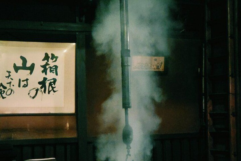 A traditional Japanese lantern emitting smoke, with a sign featuring Japanese characters. 3