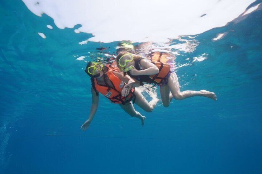 Two people scuba diving underwater. 1
