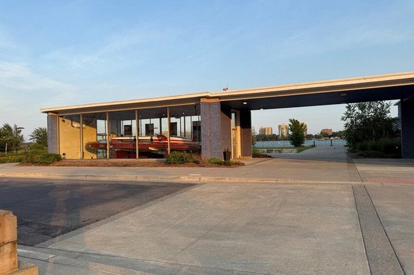 A covered parking area with a boat docked under a building. 3