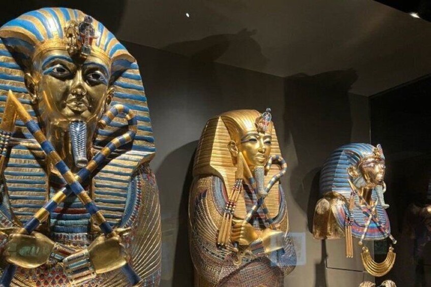 Golden sarcophagi with intricate designs and hieroglyphics. 1