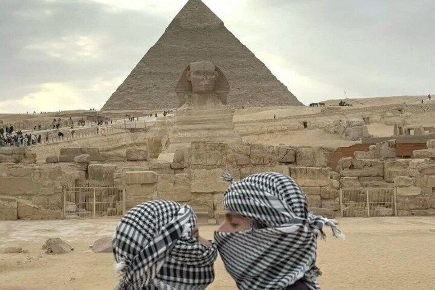 A pyramid with a large statue in the foreground. 4