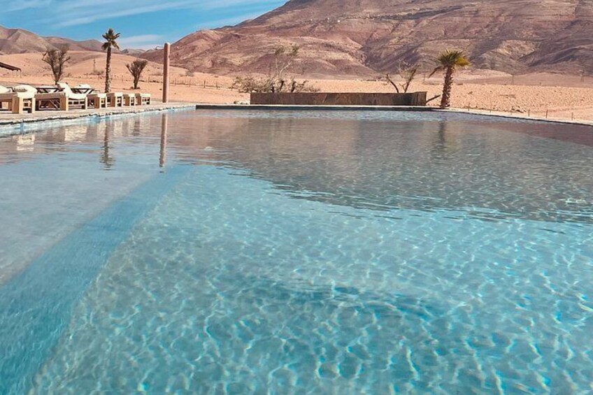 A clear pool with a desert landscape in the background. 5