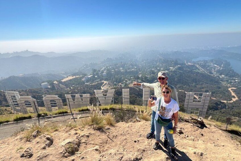 A person standing on a hill with a cityscape in the background. 2