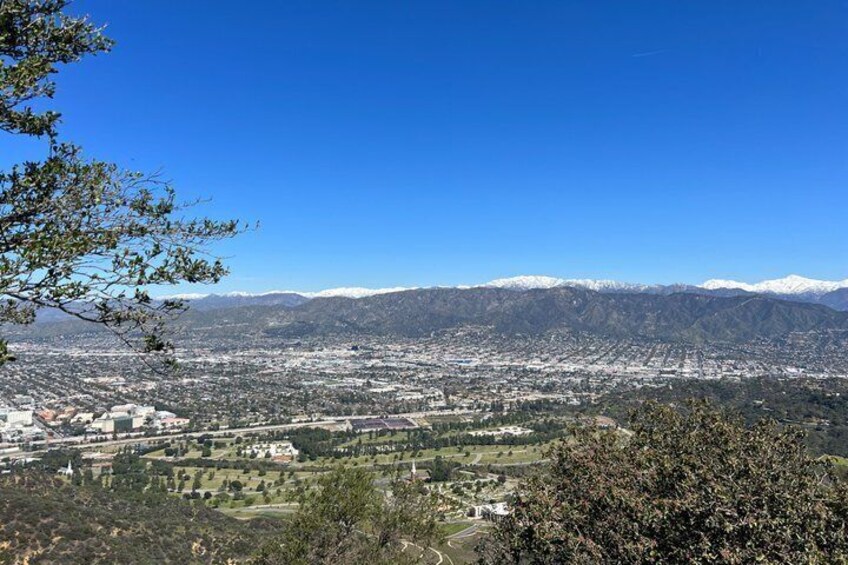 A cityscape with mountains in the background. 3