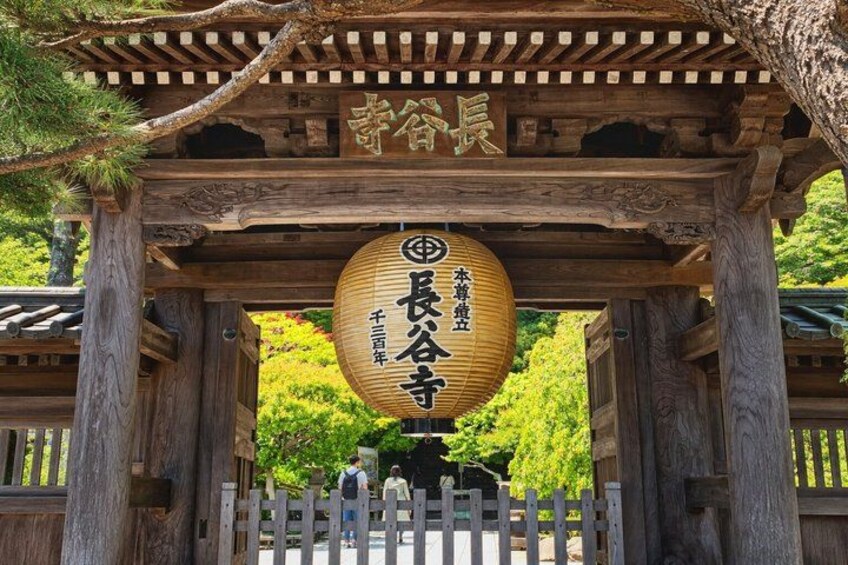 A traditional Japanese torii gate with a wooden structure and a hanging lantern. 3