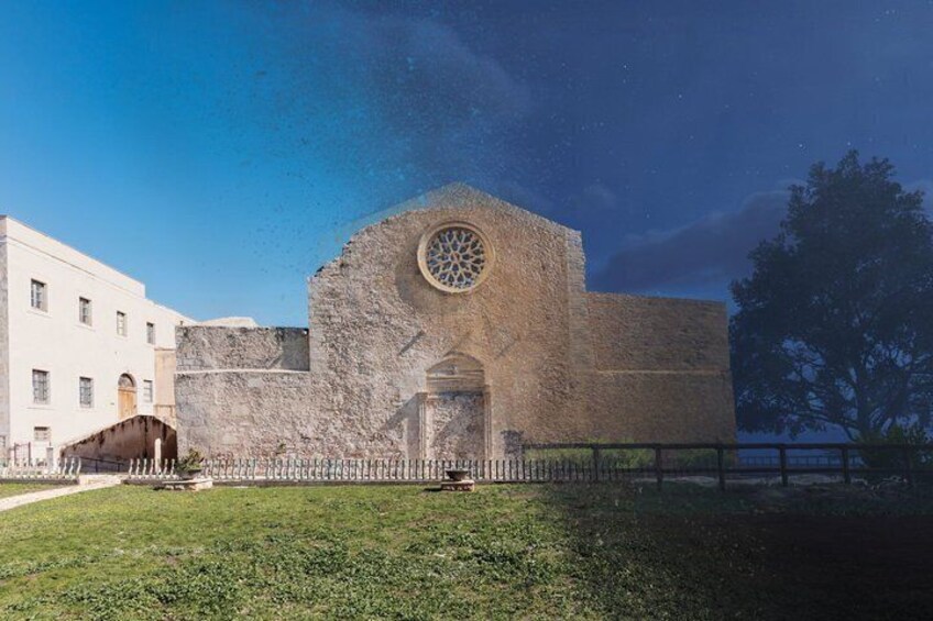 A historic building with a large circular window and a stone facade. 2