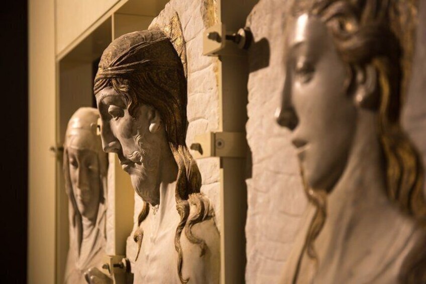 A series of classical sculptures in a museum. 2