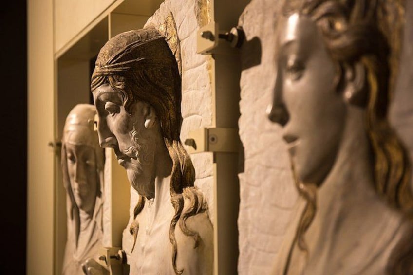 A collection of classical sculptures, possibly busts, displayed in a museum setting. 3