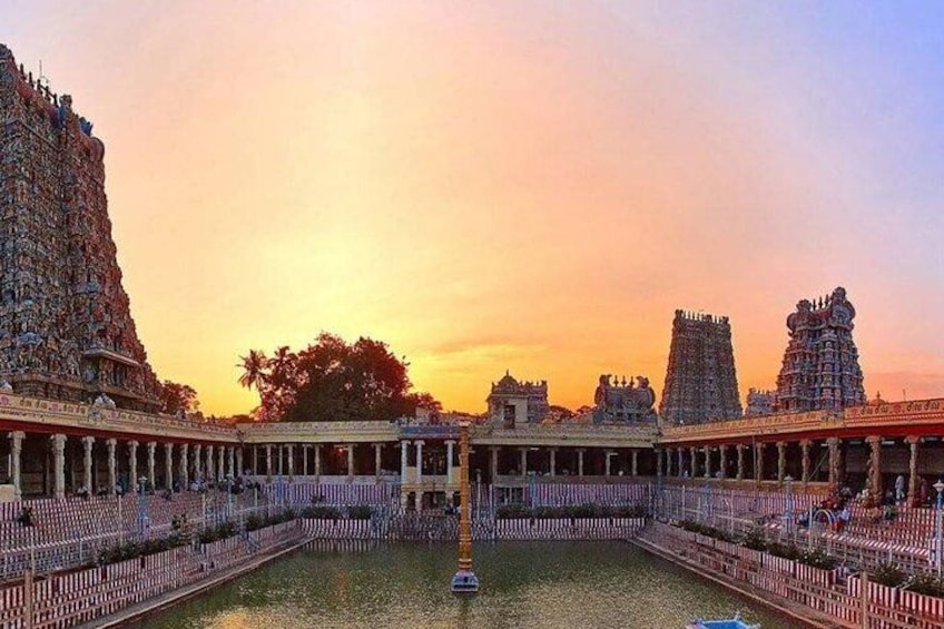 A temple complex with a central water body, multiple shrines, and a surrounding walkway. 3