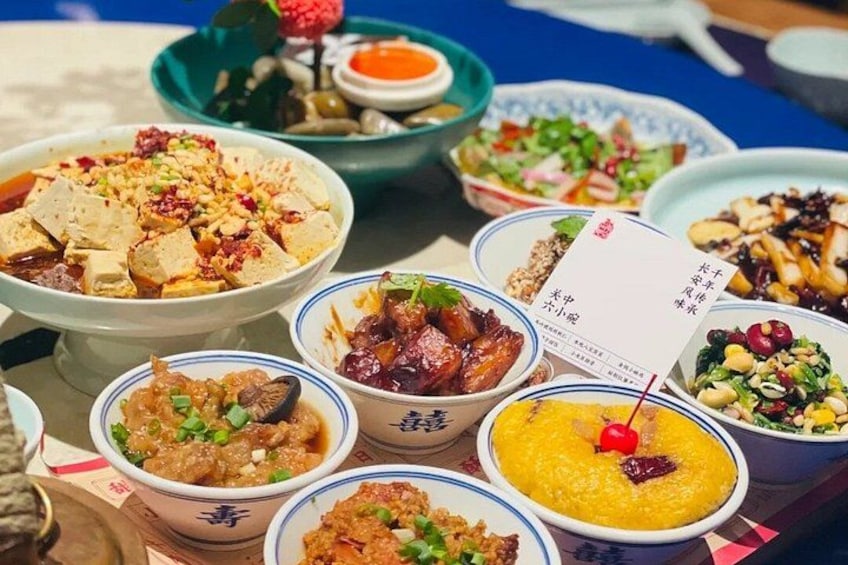 A variety of dishes in bowls with chopsticks. 2