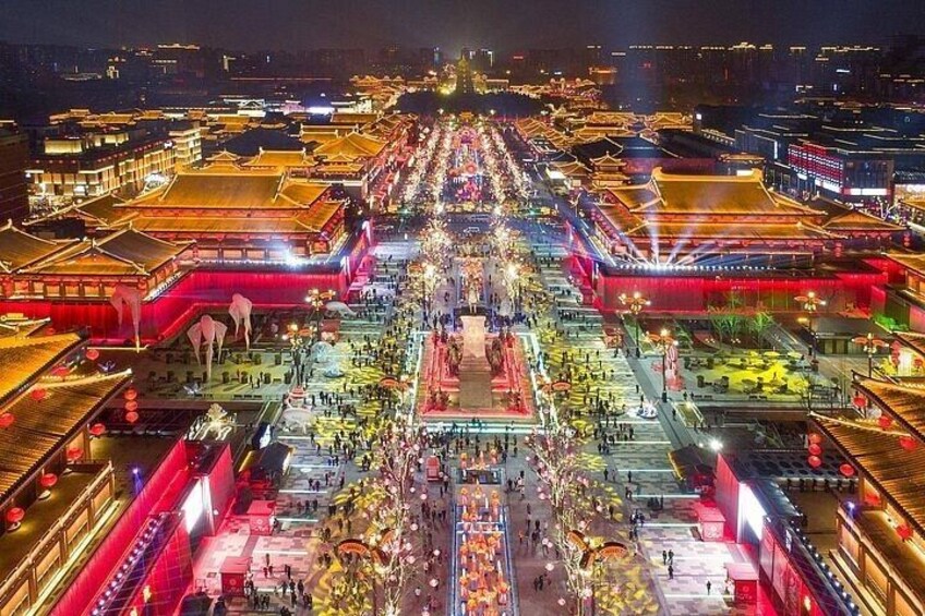 A traditional Chinese architectural complex at night, illuminated with vibrant lights. 2