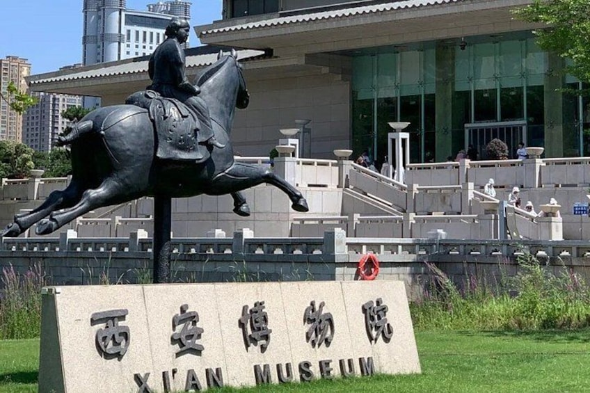 A statue of a man on a horse in front of the Xian Museum. 4