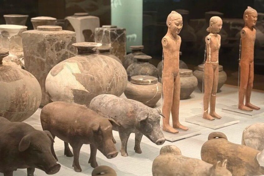 Terracotta figures, pottery, and animal sculptures in a museum setting. 2