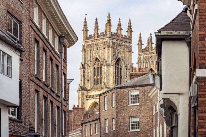A historic cathedral with Gothic architecture, surrounded by traditional brick buildings. 2
