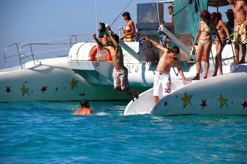 A boat with star decorations, people swimming, and a lifebuoy. 2