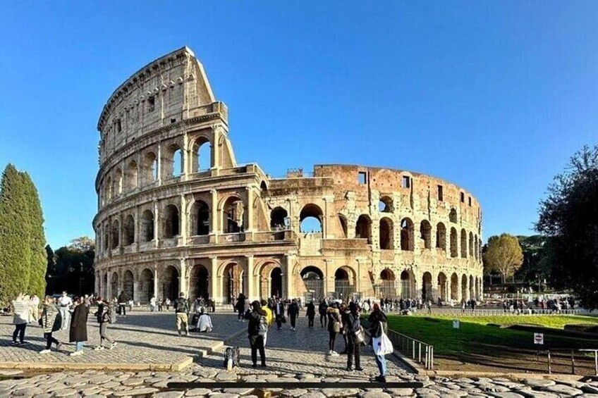 The Colosseum in Rome with tourists around. 1